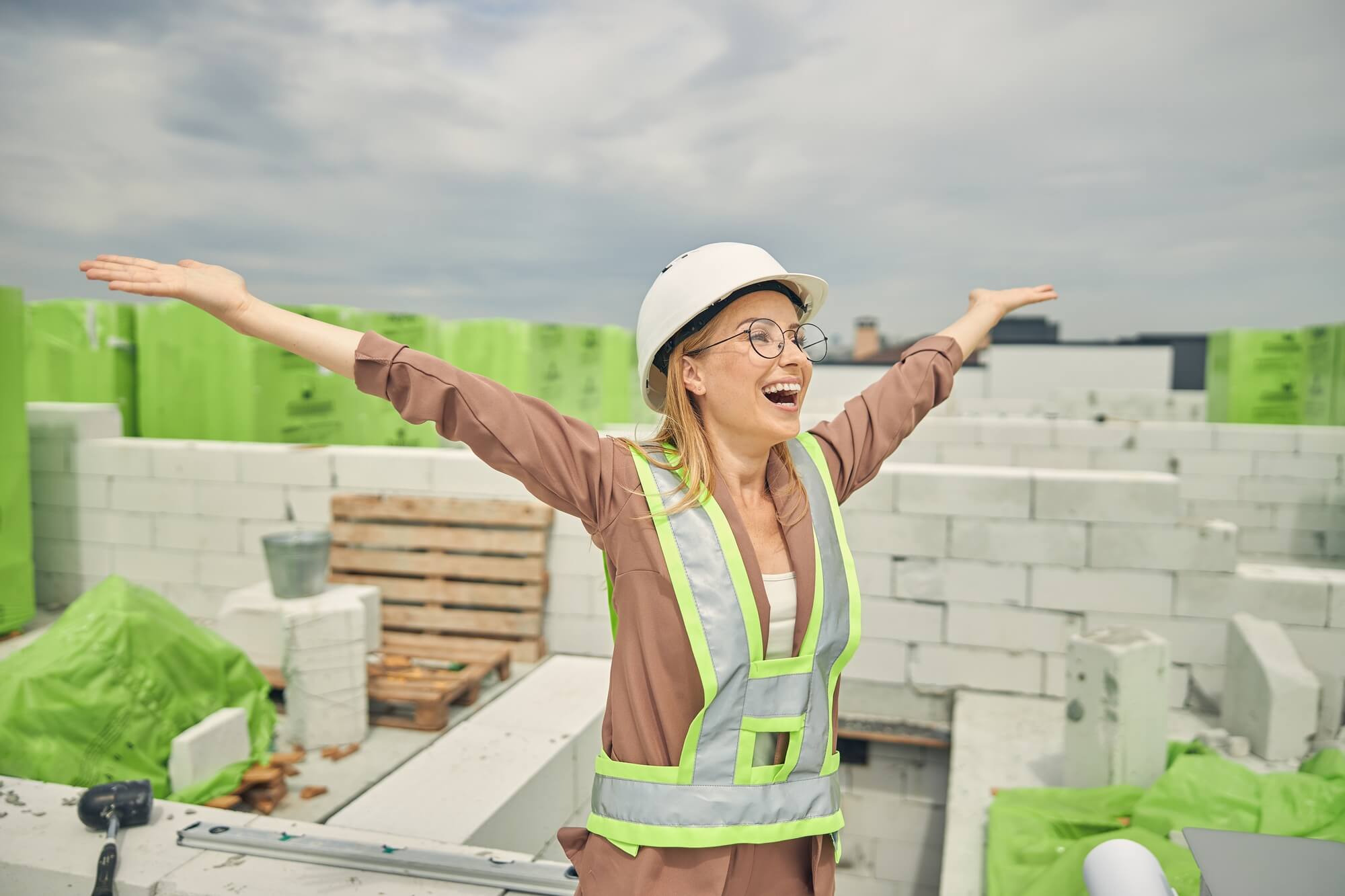 female-contractor-admiring-a-new-construction-object female-contractor-admiring-a-new-construction-object